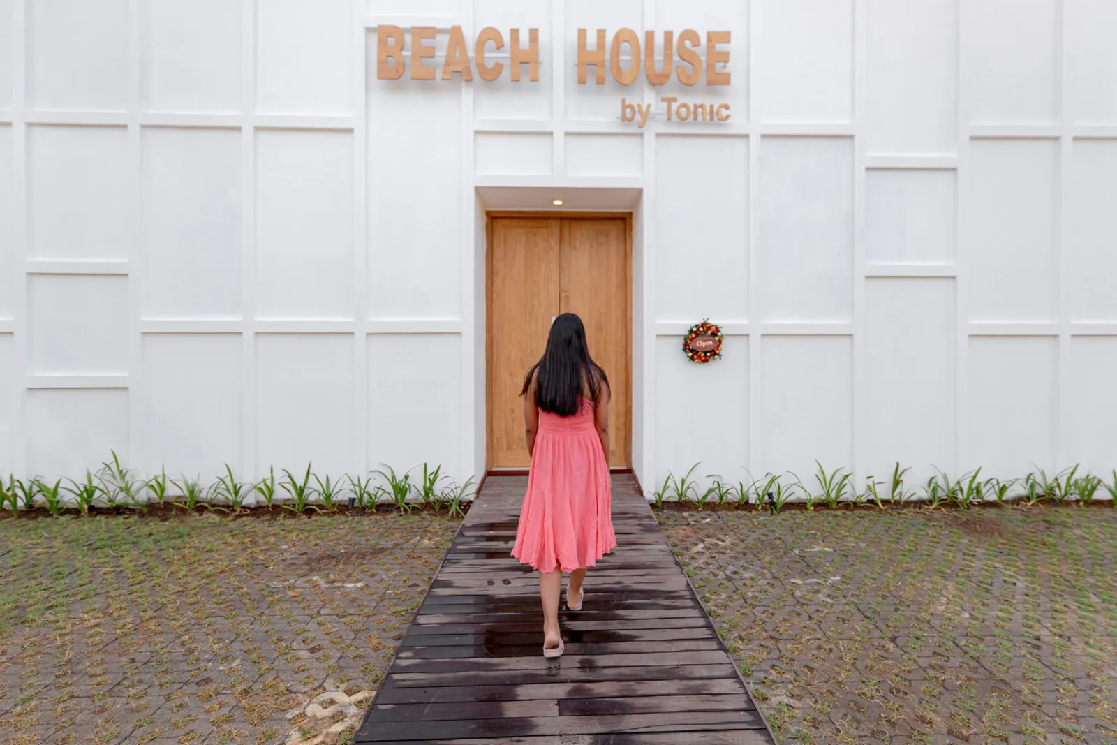 The signature white entrance of Beach House by Tonic